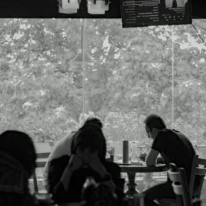 A group of people sitting at a table in a restaurant